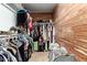 Inside a walk-in closet featuring cedar walls, there is a variety of clothing hanging on rods and baskets on the floor at 18102 E El Viejo Desierto --, Gold Canyon, AZ 85118