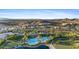 Beautiful aerial view showcasing the pool, clubhouse, and shopping with mountains as a scenic backdrop at 18387 W Mountain Sky Ave, Goodyear, AZ 85338