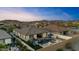 A tranquil pool with a fire feature and gazebo enhances the charm of this inviting home with mountain views at 18387 W Mountain Sky Ave, Goodyear, AZ 85338
