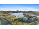 Picturesque community view overlooking the lake, mountains, clubhouse, pool and surrounding lush green landscaping at 18387 W Mountain Sky Ave, Goodyear, AZ 85338