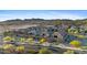 A well-planned community featuring beautiful homes, yellow flowering trees and a tranquil streetscape creates curb appeal at 18387 W Mountain Sky Ave, Goodyear, AZ 85338