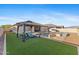 Expansive backyard showcases a pool, spa, fire pit, gazebo and turf area; perfect for outdoor living at 18387 W Mountain Sky Ave, Goodyear, AZ 85338