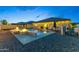 Private backyard featuring a beautiful pool, fire feature, gazebo, and manicured landscaping; great for leisure and entertainment at 18387 W Mountain Sky Ave, Goodyear, AZ 85338