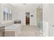 Well-lit bathroom featuring a soaking tub and glass enclosed shower at 18387 W Mountain Sky Ave, Goodyear, AZ 85338