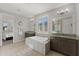 Bathroom featuring granite countertops and a centrally located tub at 18387 W Mountain Sky Ave, Goodyear, AZ 85338