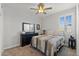 Bedroom featuring a ceiling fan, large window, and comfortable bed at 18387 W Mountain Sky Ave, Goodyear, AZ 85338