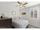 Bedroom featuring a ceiling fan, large window, and comfortable bed at 18387 W Mountain Sky Ave, Goodyear, AZ 85338
