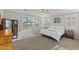 Relaxing bedroom with plush carpet, ceiling fan, and windows with shutters at 18387 W Mountain Sky Ave, Goodyear, AZ 85338
