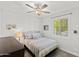 Cozy bedroom with a ceiling fan, large window, and comfortable bed at 18387 W Mountain Sky Ave, Goodyear, AZ 85338
