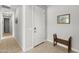 Bright entryway featuring tile flooring, a white door, and a wooden bench at 18387 W Mountain Sky Ave, Goodyear, AZ 85338