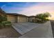 Charming home with a spacious three car garage and landscaped front yard; a welcoming sight for potential buyers at 18387 W Mountain Sky Ave, Goodyear, AZ 85338