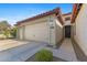 Exterior view of a well-maintained home with a spacious three-car garage and landscaped entrance at 18387 W Mountain Sky Ave, Goodyear, AZ 85338