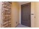 Close-up of a secure front door with decorative ironwork and stone accents at 18387 W Mountain Sky Ave, Goodyear, AZ 85338
