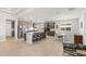 A gourmet kitchen with large island, seating, modern appliances and tile flooring at 18387 W Mountain Sky Ave, Goodyear, AZ 85338