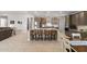 Open concept kitchen with large center island and seating for four at 18387 W Mountain Sky Ave, Goodyear, AZ 85338