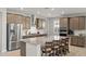 Modern kitchen with stainless steel appliances, a spacious island, and barstool seating at 18387 W Mountain Sky Ave, Goodyear, AZ 85338