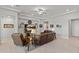 Spacious living room showcasing a media center, ceiling fan, and comfortable seating at 18387 W Mountain Sky Ave, Goodyear, AZ 85338