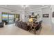 Comfortable living area with a large TV and sliding doors to the outdoor pool area at 18387 W Mountain Sky Ave, Goodyear, AZ 85338