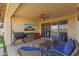 Comfortable outdoor patio with ceiling fan, outdoor kitchen, and comfortable seating, with a pool view at 18387 W Mountain Sky Ave, Goodyear, AZ 85338