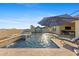 Stunning pool with water features and a spa, surrounded by travertine tile and lush desert landscaping at 18387 W Mountain Sky Ave, Goodyear, AZ 85338