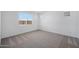 Bright and airy bedroom featuring carpeted floor and natural light from multiple windows at 18522 W Mohave St, Goodyear, AZ 85338