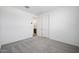 Bedroom with neutral carpet, white walls, walk-in closet with adjoining bathroom at 18522 W Mohave St, Goodyear, AZ 85338