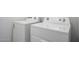 Modern white Whirlpool washer and dryer set in the laundry room at 18522 W Mohave St, Goodyear, AZ 85338