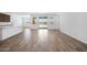 Open-concept living space featuring wood-look flooring, lots of natural light, and neutral wall colors at 18522 W Mohave St, Goodyear, AZ 85338