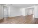 Bright and airy room with wood floors, neutral wall color, and multiple entry doors at 18522 W Mohave St, Goodyear, AZ 85338