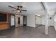 Finished basement boasts exposed brick, a ceiling fan, and an adjoining room with sliding door frame at 2501 E Campbell Ave, Phoenix, AZ 85016