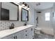 Stylish bathroom with double vanity, black fixtures, subway tile, and patterned floor at 2501 E Campbell Ave, Phoenix, AZ 85016