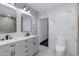 Modern bathroom with double sinks, elegant fixtures, and sleek marble tile walls at 2501 E Campbell Ave, Phoenix, AZ 85016