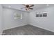 Clean bedroom with neutral decor, ceiling fan, and natural light from two windows at 2501 E Campbell Ave, Phoenix, AZ 85016
