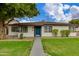 Charming single-story home with a well-manicured lawn, blue front door, and a welcoming walkway at 2501 E Campbell Ave, Phoenix, AZ 85016