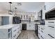 Modern kitchen with white cabinets, quartz countertops, and stainless steel appliances at 2501 E Campbell Ave, Phoenix, AZ 85016