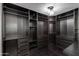 Spacious walk-in closet featuring custom shelving, drawers, and dark hardwood floors at 2501 E Campbell Ave, Phoenix, AZ 85016