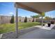 View of the landscaped backyard and covered patio at 2717 N 107Th Dr, Avondale, AZ 85392