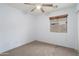 A bright bedroom with a ceiling fan and neutral carpet at 2717 N 107Th Dr, Avondale, AZ 85392
