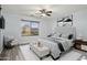 Staged bedroom featuring neutral colors, an upholstered headboard, and a sitting area at 2717 N 107Th Dr, Avondale, AZ 85392