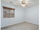 A bedroom with a ceiling fan and large window for natural light at 2717 N 107Th Dr, Avondale, AZ 85392