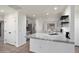 Bright kitchen features a gray marbled countertop, stainless steel appliances, and a convenient kitchen island at 2717 N 107Th Dr, Avondale, AZ 85392