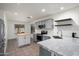 Beautifully updated kitchen with gray cabinets, stainless steel appliances, and subway tile backsplash at 2717 N 107Th Dr, Avondale, AZ 85392