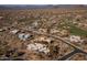 An aerial view of a residential community with a golf course, showcasing desert landscaping and mountain views at 28754 N 107Th St, Scottsdale, AZ 85262