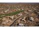 An aerial view showcases desert-landscaped properties and a lush green golf course winding through the community at 28754 N 107Th St, Scottsdale, AZ 85262