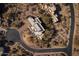 A bird's-eye view captures a modern estate with a circular driveway surrounded by desert landscaping at 28754 N 107Th St, Scottsdale, AZ 85262