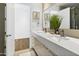 Bathroom featuring double sinks, framed mirror, and decorative greenery at 28754 N 107Th St, Scottsdale, AZ 85262