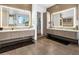 Dual bathroom vanities with illuminated mirrors and neutral color scheme at 28754 N 107Th St, Scottsdale, AZ 85262