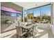 Bright dining room featuring modern lighting, stone accent wall, and views of the desert landscape at 28754 N 107Th St, Scottsdale, AZ 85262