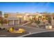 The property offers a desert-landscaped front yard, a circular driveway, and an attached three-car garage at 28754 N 107Th St, Scottsdale, AZ 85262