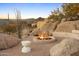This property features a cozy fire pit area set amongst desert landscaping and beautiful mountain views at 28754 N 107Th St, Scottsdale, AZ 85262